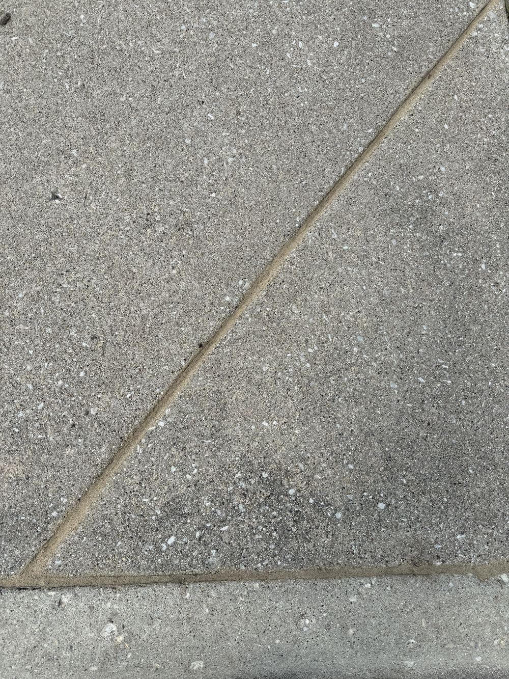 Diagonal driveway joint sealed clean and flush across the slab